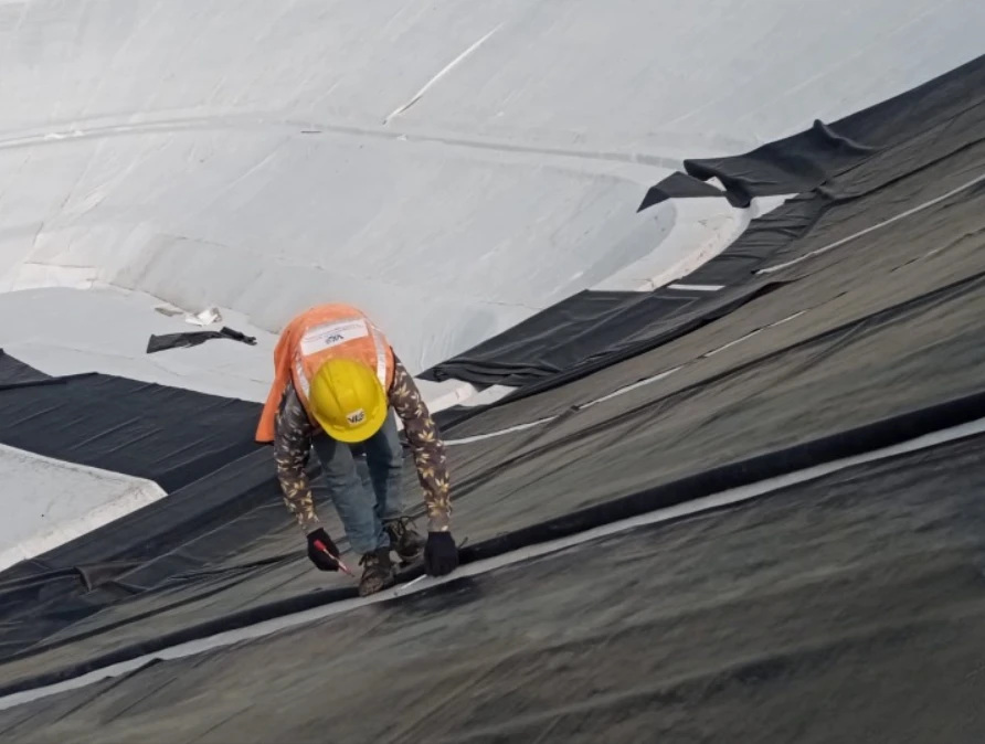 EPDM system installation using rubber membranes for industrial waste containment facility